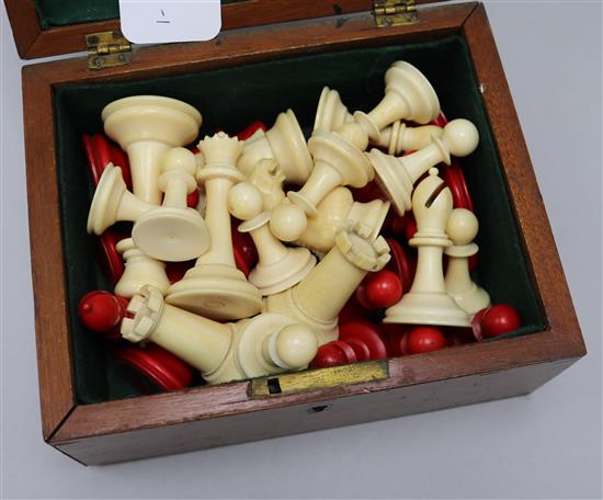 A Staunton ivory chess set, early 20th century, red stained and natural, mahogany box